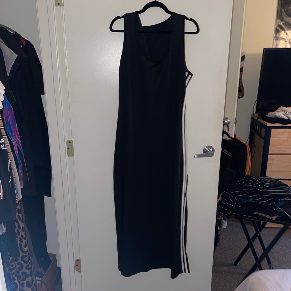 Sleeveless black maxi dress with two white stripes on left side and a spilt!